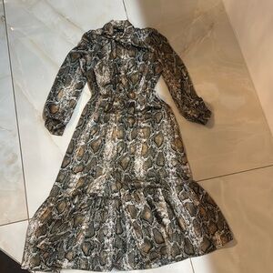 A long-sleeved midi dress featuring a snake print.